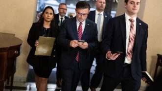 Speaker of the House Mike Johnson on his phone inside the Capitol building | Tom Williams/CQ Roll Call/Newscom