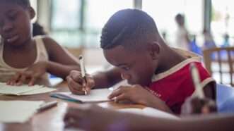 Black children learning in classroom | Photo: Santi Vedrí on Unsplash