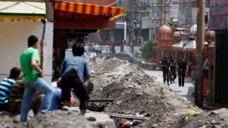 book2 | Photo: Chinese security forces stand by the entrance to a Uyghur neighbourhood in Urumqi, Xinjiang; Reuters/Nir Elias/Alamy