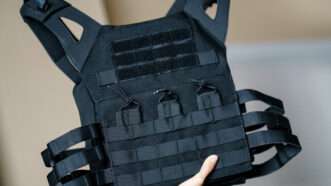 A bulletproof vest held aloft | Sirawit Hengthabthim | Dreamstime.com