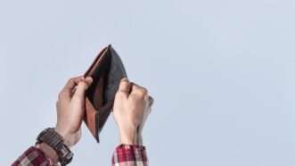 man holding empty wallet | imageBROKER/Isai Hernandez/Newscom