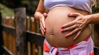 A pregnant woman holding her stomach | Photo by <a href=%40azevdoluana08d0.html Azevedo</a> on <a href=a-pregnant-woman-with-her-hands-on-her-stomach-mj1avysjiimc09e.html   