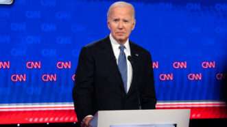 President Joe Biden stands alone on the debate stage behind a lectern. | Ben Hendren/Sipa USA/Newscom