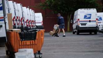 A United States Postal Service (USPS) worker loads mail into a truck to be delivered. | Alex Milan Tracy/Sipa USA/Newscom