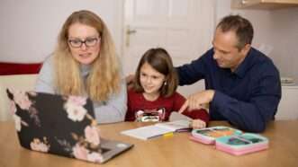 A mother and father sit with their young daughter at a table, looking at an open laptop, with an open book and an open case of colored pencils on the table. | Photo by <a href=%40sofatutorac9d.html on <a href=woman-in-blue-sweater-beside-girl-in-blue-sweater-4syo0fp1bf09678.html
				/></noscript>
			</picture>
		</div>
					</a>
					</div>
		<div class=