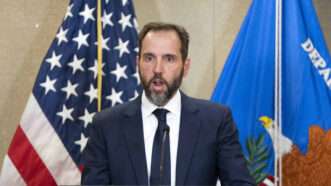 Special Counsel Jack Smith speaks in front of an American flag and a U.S. Department of Justice flag. | BONNIE CASH/UPI/Newscom